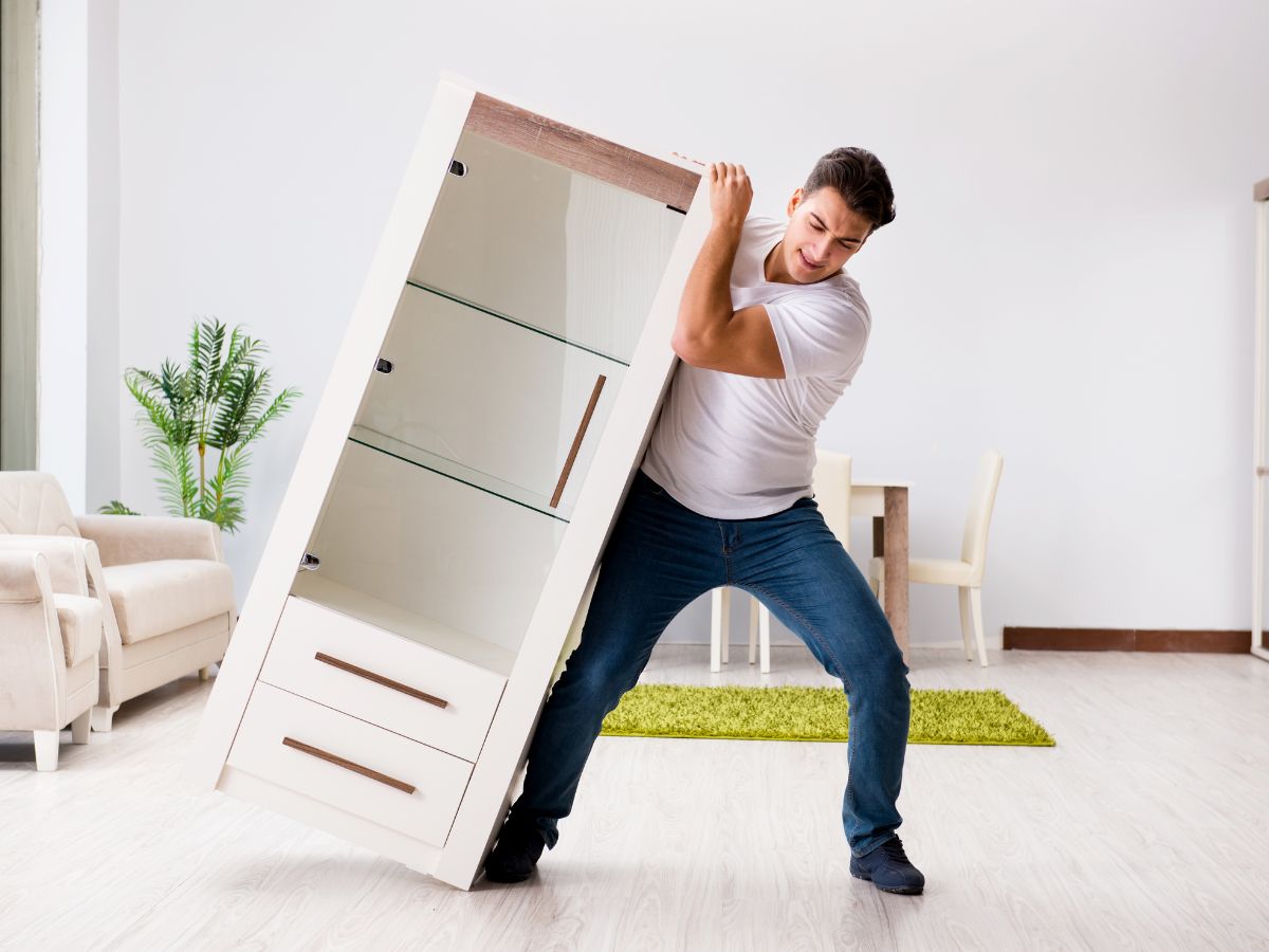 Man trying to move bookcase
